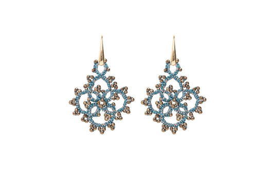 Snowflake-shaped earrings blue gold on white background