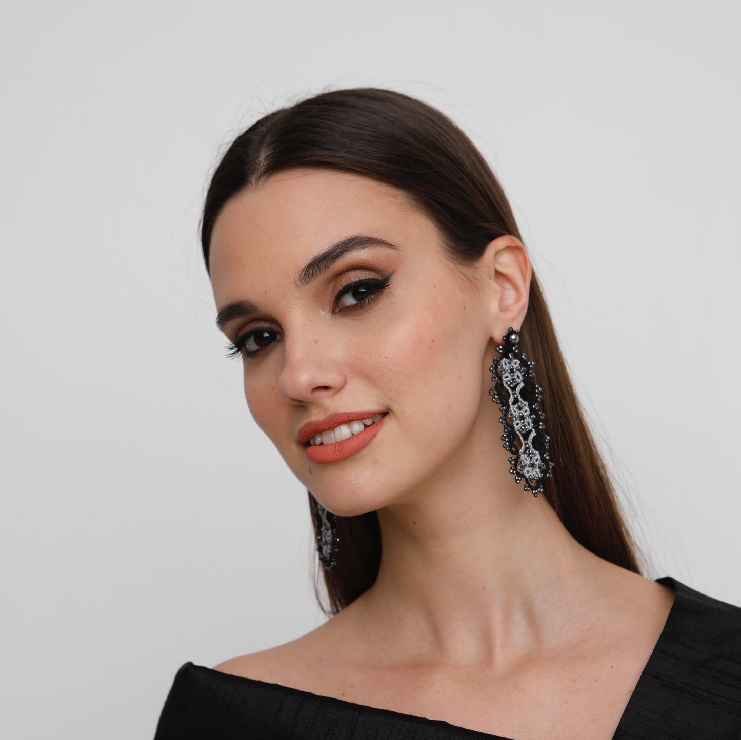 Art Deco handcrafted gemstone lace earrings being worn