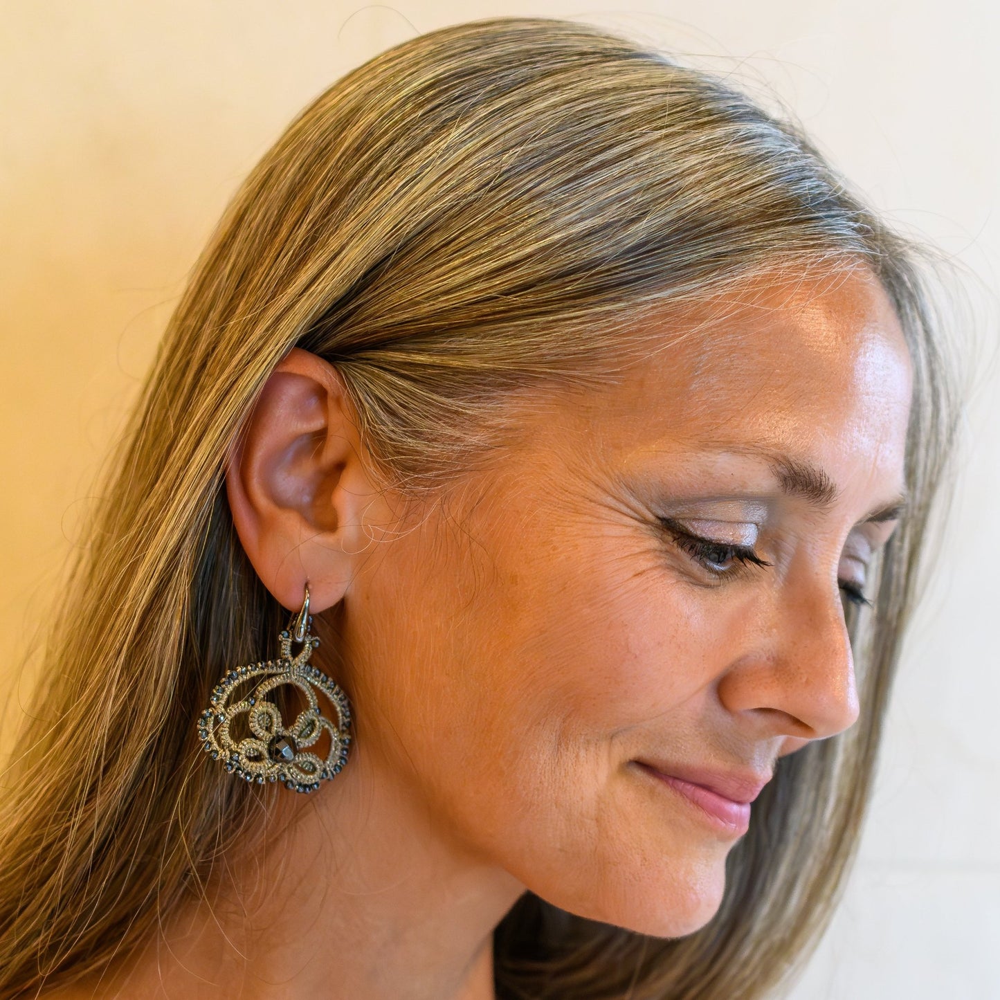 Lotus handcrafted gemstone lace earrings being worn