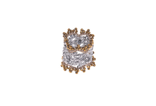 Handcrafted lace ring with gold and silver gemstones on a white background