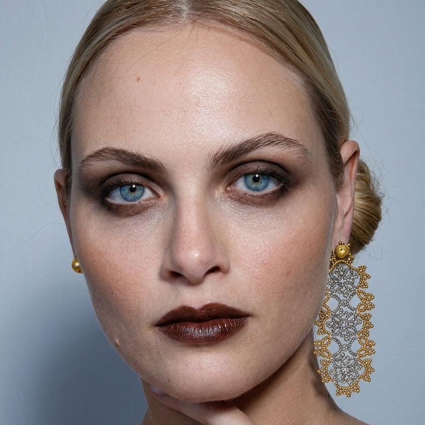 Large statement single stud handcrafted lace earring on a model

