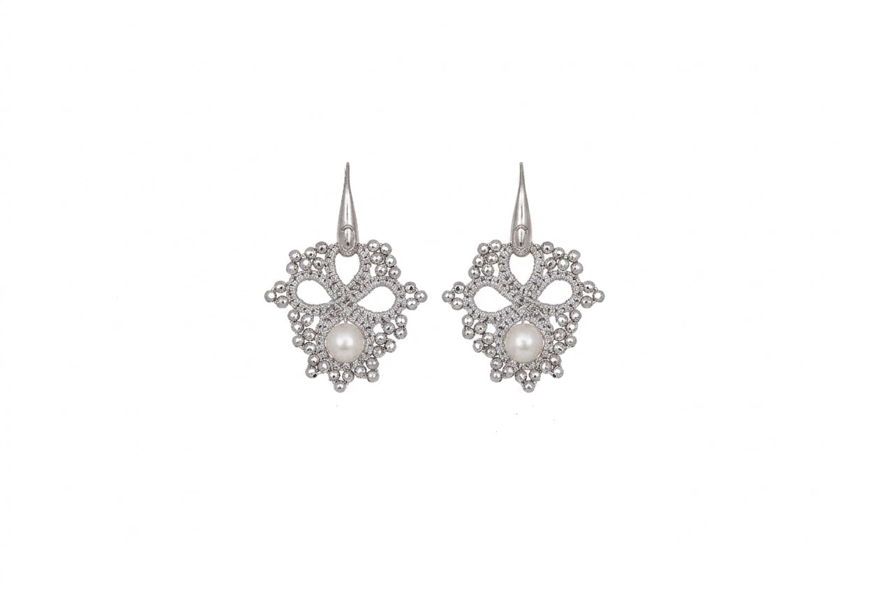 Silver handcrafted lace earrings with pearls on a white backround