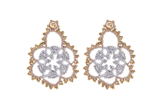 Pair of gold and silver earrings on a white background